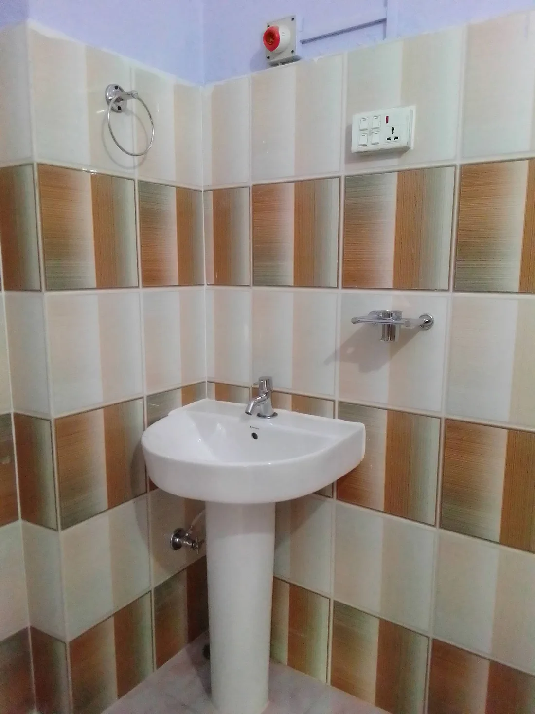 Pedestal washbasin and tap in a tiled bathroom from the business Google listing